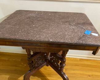 lovely antique marble top table with intricate carvings on the legs 