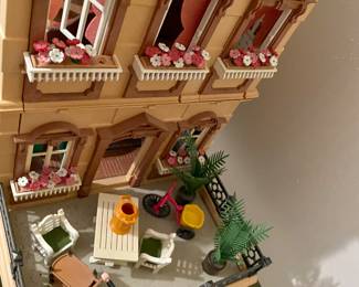 charming doll house full of furniture and other goodies , this is the side porch 