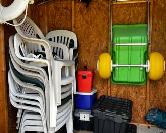 white plastic chairs, wagon (sold), coolers, storage bins