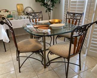 glass-top nook table with four chairs