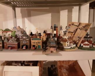 Miniature train and lighthouse figurine collectibles. Many more in boxes.