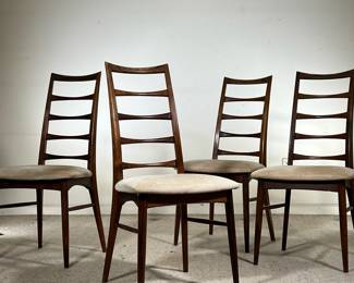 (4PC) MID-CENTURY ROSEWOOD DINING CHAIRS | Four rosewood dining chairs in dark wood, featuring cream cushions and carved rosewood ladder-back. - l. 19 x w. 17 x h. 37 in
