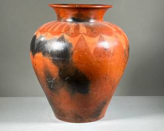 OVERSIZED ACOMA VASE | A large, oversized, burnished red earthenware vase, 22 inches tall. Featuring a design of mottled black and red glaze with decorative triangular patterns around the circumference. - h. 22 x dia. 18 in