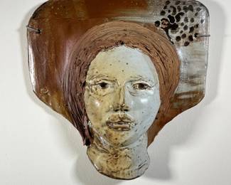 MARC CELOTTI FEMALE CERAMIC BUST | Glazed ceramic bust by Marc Celottii (American, Pennsylvania, 20th century) featuring a woman's face with a speckled glaze, intended as a decorative wall hanging. -  l. 16.5 x w. 6 x h. 16.5 in