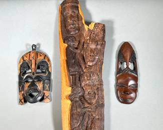 (3PC) AFRICAN WOOD CARVINGS | Three intricate wooden carvings, including two hand carved masks and larger wood carvings depicting faces and monkeys. -  l. 7 x h. 22 in