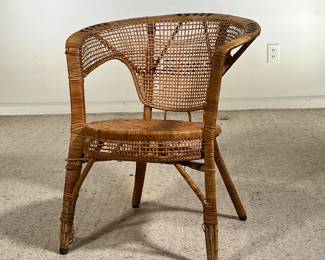 WICKER CHAIR | Antique woven wicker chair with a rounded back, armrests, and braided black accents. -  l. 24 x w. 20 x h. 27.5 in