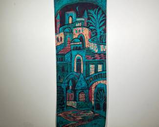 BATIK CITYSCAPE PAINTING | Batik hanging scroll in deep blue, red, and yellow dyes, depicting a series of houses, buildings, and staircases. Signed lower left. - w. 15.5 x h. 42.5 in