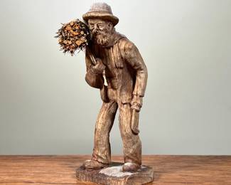 HAND CARVED WOODEN STATUE | Small, hand-carved wooden statue, depicting an elderly man carrying a bundle of sticks. - l. 3 x w. 3 x h. 6.5 in