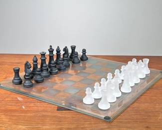 GLASS CHESS SET | Clear glass chessboard featuring sandblasted glass white pieces and black glass pieces. - l. 15 x w. 15 in