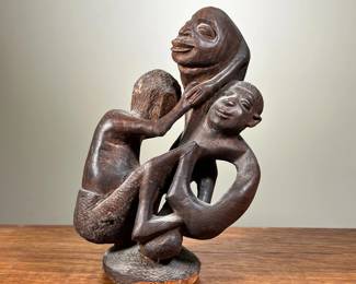 HAND CARVED AFRICAN STATUE | Shows motherly figure holding two children. - l. 5 x w. 5 x h. 9 in