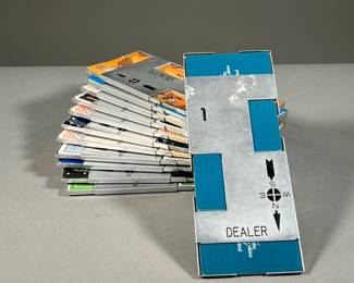 (12PC) VINTAGE ABCL METAL CARD HOLDERS | Metal card holders from ABCL, numbered 1-12 with directional compass and rotating dealer position. Including cards from vintage airlines and more. - l. 9.5 x w. 3.75 in