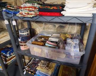 Hundreds of yards of cotton quilting fabric and fat packs.