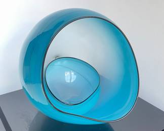 Chihuly Blue Sky Basket Set, sitting on its vitrine base. 