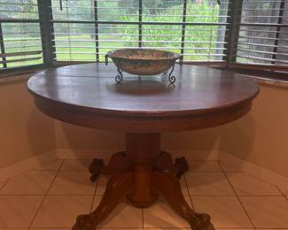 Antique 45" Oak Lion Claw Foot round table on casters. 