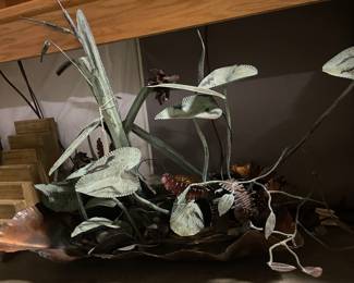 Sculpture water feature of pond, Lily pads and cattails. 