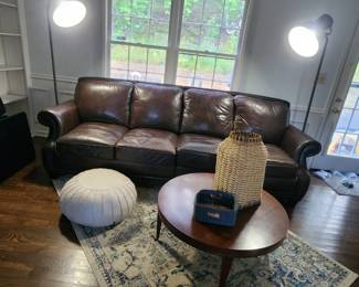 4 CUSHION LEATHER SOFA WITH STUDDED-EDGE, VINTAGE COFFEE TABLE, POUF, PAIR OF MATCHING FLOOR LAMPS