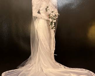 Wedding Dress from 1993. Worked really well -- still married! Includes gown, veil, and train. Was professionally cleaned and sealed after wedding and has been boxed in air conditioned storage since. (Size 6)