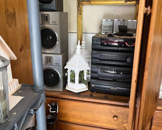 stereo equipment, speaker,  gold frame, small bird feeders,  pine cabinet...