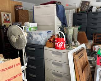 Garage is packed! Large 4 drawer cabinets, floor fan, folding wood chairs, blower, vintage round coke cooler, metal vases and more. 