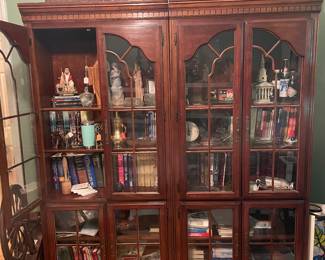 Great 2 piece display cabinet and it is packed, beside it is a antique spinning wheel.