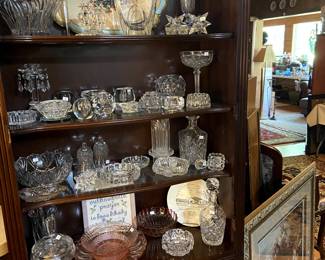 Lighted hutch with various crystal and glass pieces.