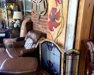 Comfy leather club chair with matching ottoman, stained glass fire screen, rustic door, large painting by Jennifer Coleman of AR.
