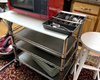 Stainless rolling cart, red microwave.