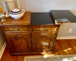 Henredon serview with laminated surface to help protect from moisture and heat when using for serving