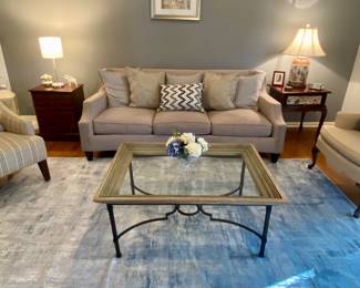 Living room with coffee table glass top, wood edge and metal base