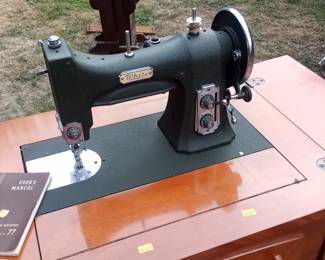 antique White sewing machine in cabinet with bench