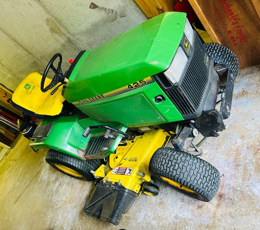 John Deere 425 tractor with mowing deck and snowblower