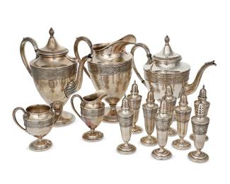 1001
Early 20th century
A Group Of International Sterling "Wedgwood" Silver Items
Marked: International Sterling / Wedgwood
Comprising a coffee pot (11.5" H x 10.5" W x 5.5" D), a teapot (10.25" H x 11" W x 5.5" D), a water pitcher (10.25" H x 8.5" W x 5.5" D), a creamer (5.25" H x 4" W x 2.625" D), a sugar bowl (4.75"H x 5.325" W x 3.25" D), and four pairs of salt and pepper shakers (each: 6.25" H x 2" Dia.), personalized, 13 pieces
97.375 gross oz. troy approximately
Estimate: $1,200 - $1,800