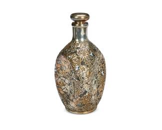 1026
Early/mid-20th century
A Japanese Sterling Silver Overlay Pinch Bottle
Marked to underside silver: Sterling / Japan / 950
The three-sided glass bottle with all-over sterling silver overly in a floral motif surmounted by a cork stopper
8.75" H x 5" W x 5" D
Estimate: $200 - $300