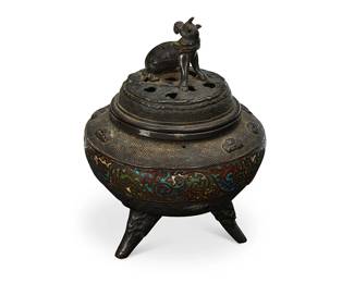 1032
Meiji Period 1868-1912 or later
A Japanese Champlevé Enamel And Bronze Censer
Appears unmarked
The lidded vessel with a kirin final surmounting the squat body with repeating honeycomb patterning in low relief interspersed with stylized clouds in higher relief, flanking centered enameled banding and set upon tripod feet
8" H x 7" Dia.
Estimate: $500 - $700