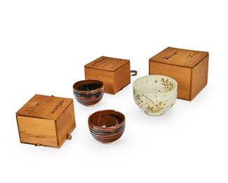 1034
Late 20th century
A Group Of Japanese Studio Ceramic Bowls
Each stamped with Kanji characters to the underside; further marked with Kanji characters to the box housing
Comprising two ceramic "Kita ware" black tea bowls with brown "Ko Seto" style glaze and one pale green glazed ceramic bowl with pierced accents and decorated with foliate motif, each in their own original boxes, two of which are wrapped in ribbons, 3 pieces
Largest box: 6" H x 7.75" W x 7.75" D; smallest box: 4.5" H x 6" W x 6" D
Estimate: $1,000 - $1,500