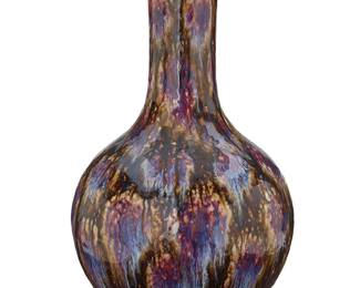 1040
Late Qing Dynasty 1644-1911 or later
A Chinese Flambé Glazed Porcelain Tianqiuping Vase
Appears unmarked
The stick neck ceramic vase with an all-over splashed glaze in shades of iridescent blue, purple, and black on a beige ground
15" H x 8" Dia.
Estimate: $200 - $300