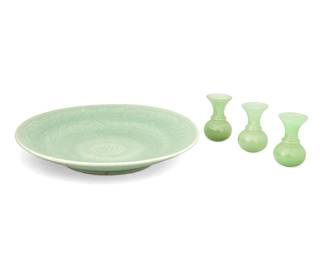1048
20th century
A Chinese Celadon Ceramic Platter With Three Peking Glass Vases
Each appears unmarked
The celadon glazed earthenware platter with incised foliate motifs along with three Peking diminutive jadeite glass vases, 4 pieces
Platter: 2.25" H x 13.25" Dia.; each vase: 3.5" H x 2" Dia.
Estimate: $100 - $200