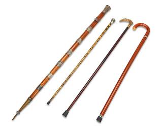 1056
19th/20th century
A Group Of Walking Sticks And Canes
Each appears unmarked
Comprising one wood cane with metal juncture and rubber tip, one wood cane with brass handle in the form of a fox, one tiger eye cane with abalone and mother of pearl inlay below a silver metal cap, and one wood walking stick with silver metal chased foliate bands and cap, 4 pieces
Largest: 45" H x 2" Dia.; smallest: 34.125" H x 1.325" Dia.
Estimate: $300 - $500