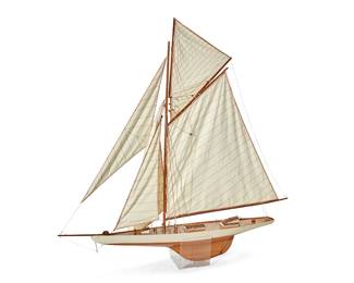1058
Mid-20th century
A Sloop Sailboat Model
Appears unmarked
The scale wood model featuring a white partially painted hull with red trim, detailed riggings, and five cotton canvas striped sails
44" H x 47.5" W x 7" D approximately
Estimate: $400 - $600