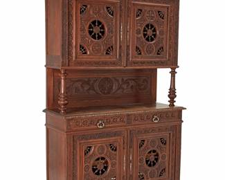 1063
Late 19th century
A Victorian Carved Walnut Sideboard
The sideboard with all-over carved floral and foliate motifs and openwork spindle accents, comprising an upper two-door hutch with attached back panel and turned supports over a lower section with two drawers and a two-door cabinet, raised on turned feet
89.75" H x 55.5" W x 20.75" D
Estimate: $200 - $400