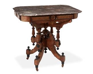 1066
Late 19th/early 20th century
A Victorian Renaissance Revival Carved Wood Side Table
The table with grey and brown marble top set on carved and turned wood frame with incised and gilt-filled accents, alternately decorated at joints with ball finials and drop finials raised on four scroll and leaf-form legs with metal casters
32" H x 33.5" W x 25" D
Estimate: $200 - $300