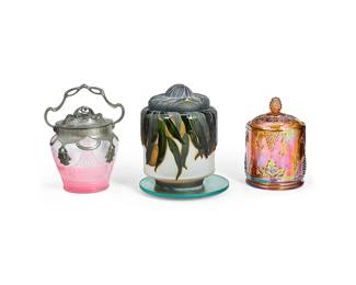1074
20th century
Three Glass Lidded Biscuit Barrels
Each appears unmarked
Comprising one iridescent brown molded glass lidded jar with grape motif, one Art Nouveau cased and acid etched jar with pewter overlay, handle, and lid, and one cased and acid etched lidded jar depicting stone fruit and leaves, mounted on a mirrored rotating base, 3 pieces
Largest: 8.25" H x 6.75" Dia.; smallest: 7" H x 4.5" Dia.
Estimate: $200 - $300