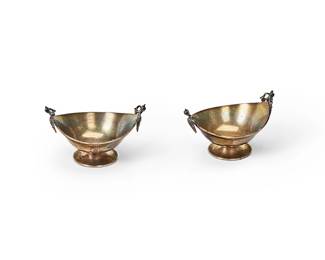 1079
Earl/mid-20th century
Two Sterling Silver Nut Dishes
Each with hallmarks for sterling, Rhode Island, and Gorham
The nut dishes with opposed handles of pierced ribbon form over low-relief profiles of a female face, 2 pieces

Each: 2.25" H x 3.5" W x 2.625" D
3.56 oz. troy approximately
Estimate: $200 - $300