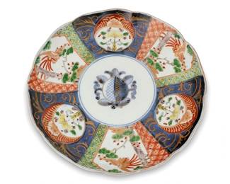 1085
Late Meiji Period 1868-1912 or later
A Set Of Japanese Imari-Style Porcelain Plates
Nine marked to the underglaze of the underside for unknown artist
Each painted and gilt plate with six registers, alternating between avian motifs on white ground and floral motifs on navy ground, centering a peach, with ribbons to the exterior, 10 pieces
Each: 10" Dia.
Estimate: $200 - $400