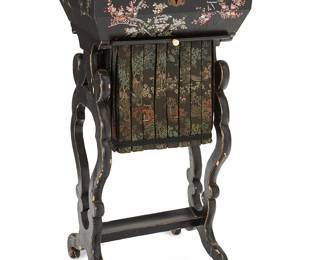 1101
Late 19th/early 20th century
A Chinese Shell Inlaid Lacquer Sewing Table
Appears unmarked
The black lacquered hinged box on scrollwork legs, all with mother-of-pearl and abalone inlay, the tabletop depicting a rooster and hen amongst cherry blossoms and other foliate motifs; the interior fitted with a compartmentalized tray and embroidered silk sewing bag underneath
30" H x 14.5" W x 10.5" D
Estimate: $200 - $300