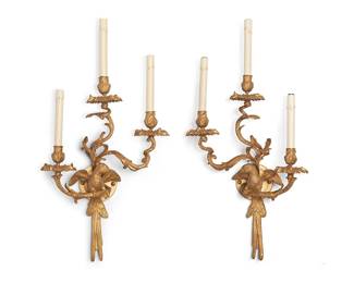 1115
Early/mid-20th century
A Pair Of French Gilt-Bronze Parrot Wall Sconces
Each appears unmarked
Two three-light, wall-mounted sconces, each with a parrot perched on one of the foliate arms, each arm terminating in a flower petal bobeche and faux candle, electrified, 2 pieces
Each: 28" H x 15" W x 7.5" D approximately
Estimate: $400 - $600