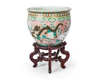 1124
Republic Period 1912-1949 or later
A Chinese Famille Rose Enameled Fishbowl
Appears unmarked
With enameled dragon bat motifs to exterior in a Famille Rose palette and fish and aquatic plant motifs to the interior; along with a carved wood stand, 2 pieces
With stand: 20.5" H x 14.5" Dia.
Estimate: $300 - $500