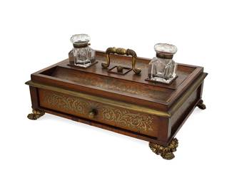 1146
Late 19th/early 20th century
A Continental Boulle Ink Stand
The wood inkwell stand with foliate brass Boulle inlay, featuring two inset glass inkwells over a single drawer
8" H x 15.5" W x 11.25" D
Estimate: $200 - $400