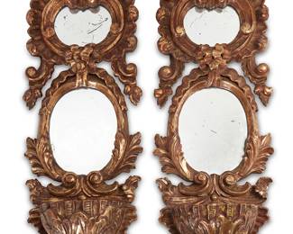 1150
Late 19th/early 20th century
A Pair Of Italian Venetian-Style Giltwood Wall Mirrors
Each appears unmarked
Two Grotto-style, gilt-framed mirrors, each with stacked oval mirrors in Rococo carved frames replete with a decorative faux fountain basin at the base of each, 2 pieces
Each: 39" H x 13.5" W x 6.75" D
Estimate: $800 - $1,200