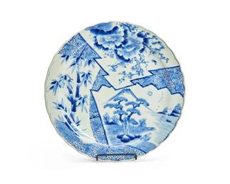 1176
Meiji Period 1868-1912 or later
A Japanese Blue And White Porcelain Charger
Appears unmarked
With randomized registers separated by jagged lines depicting various foliate scenes, all rendered in blue underglaze on a white ground
2" H x 18.5" Dia.
Estimate: $500 - $700